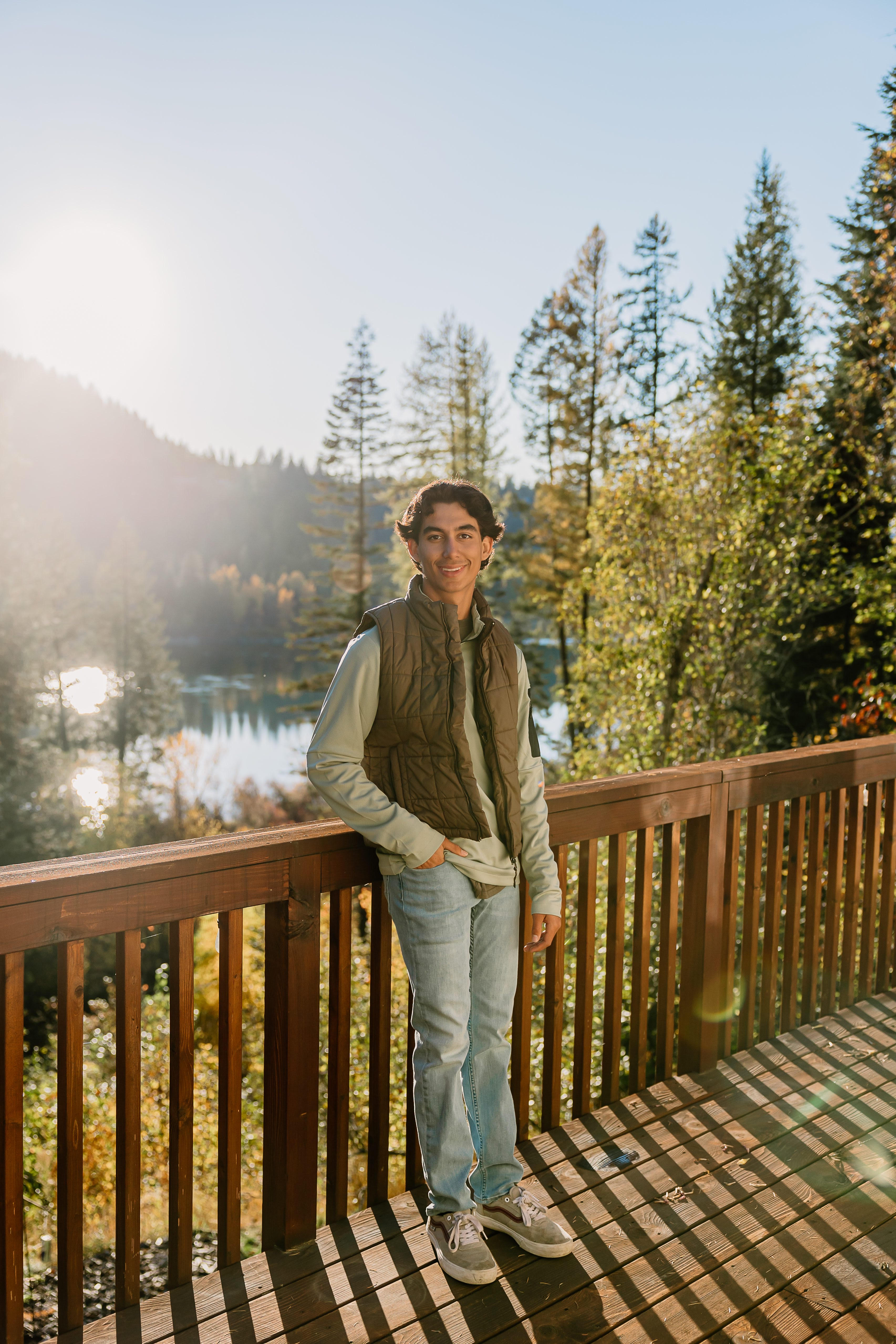 Portrait on deck overlooking mountains and lake